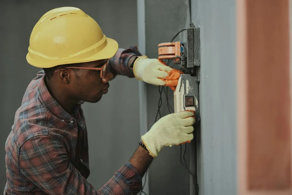 Professional appliance technician working on washer unit in Belleville